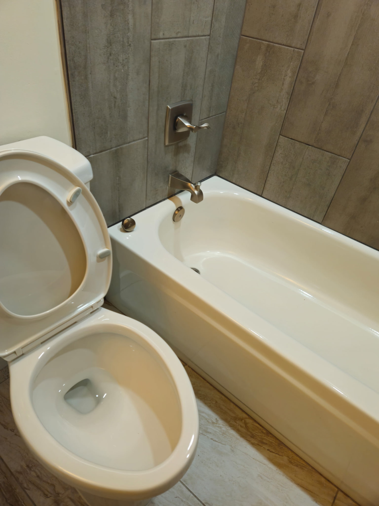 Spotless bathroom with clean toilet and bathtub