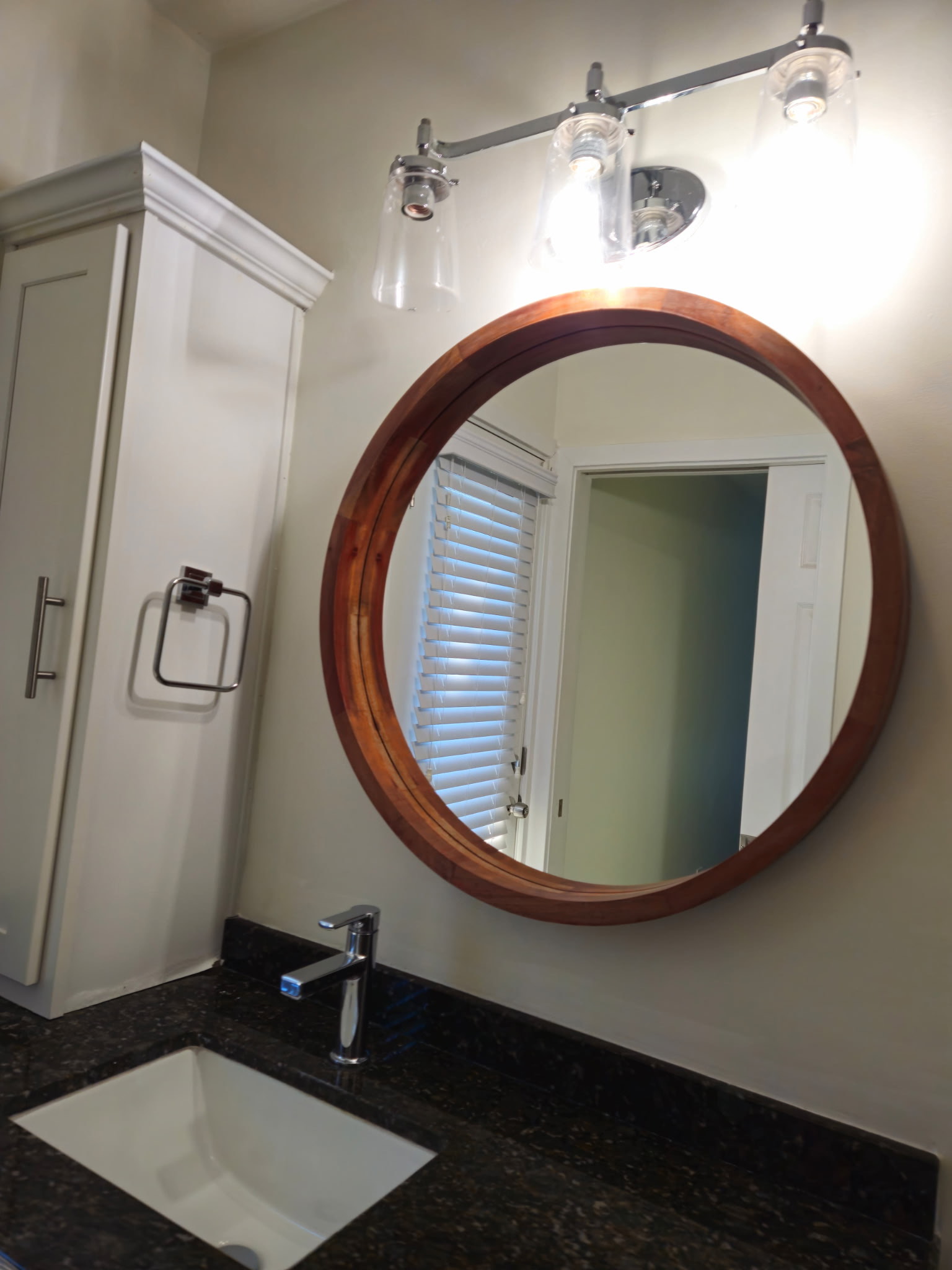 Sparkling bathroom vanity with round mirror